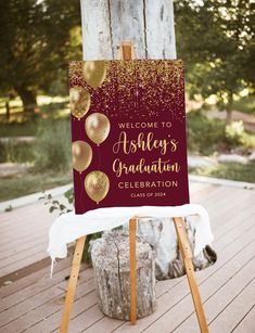 an easel with a sign that says, welcome to ashley's graduation celebration