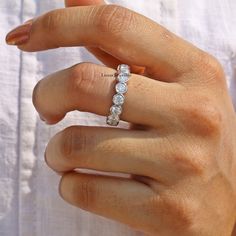 a woman's hand with a diamond ring on it