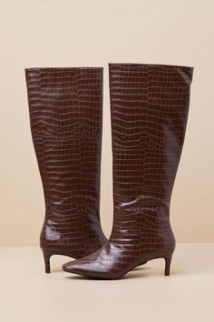 Strut through the changing season with confidence in the Lulus Rohmer Chocolate Croc-Embossed Over-the-Knee Boots! Crocodile-embossed faux leather shapes these fashionable boots with a pointed-toe upper that rises to a 16.25"" over-the-knee shaft with a 15"" circumference. A 7"" zipper at the instep makes for easier on-and-off, all atop a low stiletto heel. 2. 25" wrapped stiletto heel. Cushioned insole. Rubber sole has nonskid markings. Man Made Materials. Imported. Lulus | Rohmer Chocolate Cro Luxury Brown Elegant Knee-high Boots, Brown Crocodile Boots, Elegant Brown Knee-high Boots With Sculpted Heel, Brown Crocodile Tall Boots, Elegant Brown Knee-high Boots Medium Width, Crocodile Boots, Luxury Brown Knee-high Cowboy Boots, Low Heel Boots, High Leather Boots