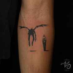 a man's arm with a tattoo on it that has a bird flying over him