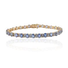 This is part of Chairish’s Fine Jewelry assortment.  Blue Sapphire and Diamond Tennis Bracelet in 14K Gold showcases 31 endlessly sparkling natural  sapphires weighing 10.39 carats and diamonds weighing 0.75 carats. It measures 7.5 inches long in length.  Sapphire stimulates concentration and reduces stress. Designed with perfect oval cut blue sapphire with two diamond in between each sapphire to make you stand out on any occasion or event. The elegant style complements the attire beautifully an Blue Tanzanite Gemstone Bracelets, Fine Jewelry Sapphire Gemstone Tennis Bracelet, Sapphire Gemstone Tennis Bracelet In Fine Jewelry Style, Fine Jewelry Sapphire Tennis Bracelet, Sapphire Bracelet With Prong Setting, Blue Tanzanite Bracelet Jewelry, Fine Jewelry Sapphire Tennis Bracelet With 17 Jewels, Formal Blue Tanzanite Bracelets, Blue Tanzanite Bracelet