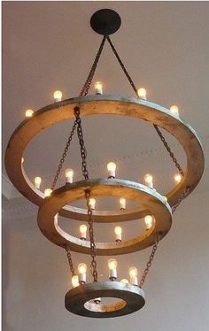 a circular chandelier with lights hanging from it