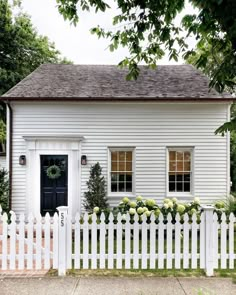 a white house with a black door and window