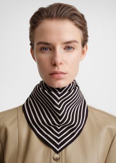 Signature TOTEME scarf woven from featherlight silk yarns. It has a square shape measuring 57x57cm that's printed with a black and crème monogram in the middle. Wear it around your neck or over your shoulders.