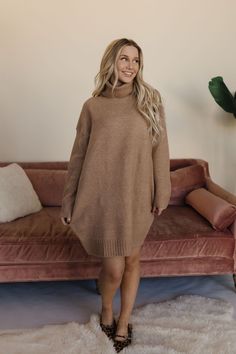 Stay warm and stylish this winter with the Tabina Thick Turtleneck Sweater Dress. Made with a soft and cozy camel base and knitted detailing, this dress is perfect for any occasion. Its loose fit and above knee length make it great for dressing up or down, and it's holiday party ready! Paired with THE CHIC POINTED TOE FLATS IN LEOPARD & THE ORGANIC CIRCLE BUCKLE BELT IN BLACK. Thick turtleneck Loose fit Above knee length Camel color 72% Acrylic 24% Polyester 4% Spandex Length (shoulder to hem): Thick Turtleneck Sweater, Thick Turtleneck, Summer Goddess, Turtleneck Sweater Dress, Exclusive Clothing, Nursing Friendly, Pointed Toe Flats, Camel Color, Buckle Belt