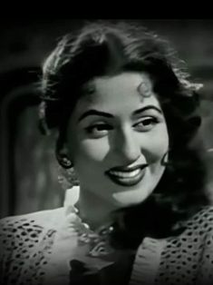 an old black and white photo of a woman smiling