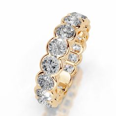 a yellow gold ring with five round diamonds