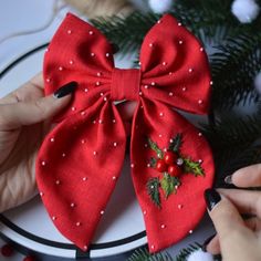 someone is making a christmas bow on a plate