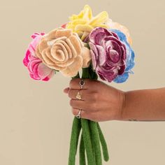 a person holding a bunch of flowers in their hand