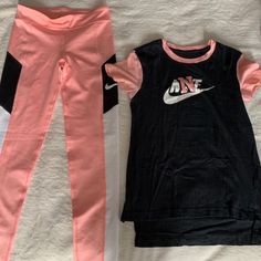 Featuring A Nwot Girls Nike Drift Fit Legging Set Coral Pink/ Black Coral Pink Legging (L) Shirt Size (M) This Set Comes With An Additional Free Pair Of Black Nike Leggings With Coral Pink Nike Logo. Size Xl Body 83% Polyester, 17% Spandex Cute Set!!!! Nike Sporty Sports Sets, Casual Nike Sports Sets, Casual Pink Spring Activewear, Nike Fitted Sports Sets, Fitted Nike Sports Sets, Pink Cotton Activewear For Workout, Trendy Pink Activewear, Pink Cotton Workout Activewear, Fitted Black Activewear