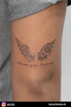 a woman's thigh with an angel wing tattoo on her leg and the words, always