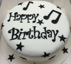 a happy birthday cake with music notes and stars