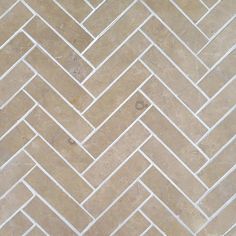 a tile floor with white and brown herringbones on the bottom, in an angled pattern