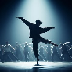 a man is dancing on stage with his arms spread out in front of the crowd