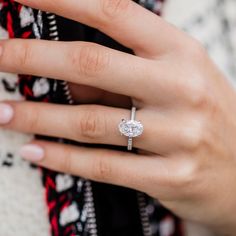 a woman's hand with a diamond ring on her finger