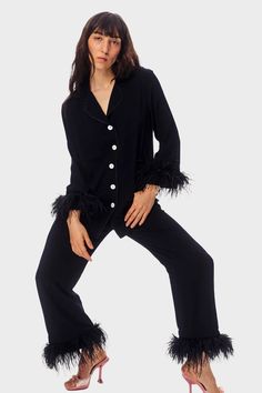 Join the fun with this Black Party Pajama Set with detachable feather cutts. This black PJ set features a classic button down shirt with rounded collar and piping details. The sleeves are cropped perfectly to celebrate the ostrich feather cuff. The pants have an elastic waistband, sitting low on the hip with a straight silhouette letting you style these stunning pants any which way. Pair with a chic mule for a fashion forward evening on the town, and of course they are perfect for a girls weeken Black Pjs, Daily Sleeper, Feather Pajamas, Party Pajamas, Feather Cuffs, Shirt And Pants Set, Ostrich Feather Trim, Pjs Set, Womens Pjs