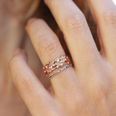 a close up of a person's hand with a ring on their finger,