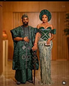 a man and woman dressed in traditional african clothing