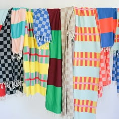 several colorful towels hanging on a clothes line