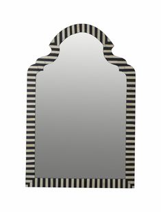 a black and white striped mirror sitting on top of a table