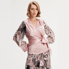 Cut from an acetate fabric mixed with a veil printed on the sleeves, this piece highlights the silhouette with elegance. V neckline and waist tightened by a belt. To wear at the office with formal pants or a pencil skirt or play the "total" look with our "Long chiffon skirt with ruffles floral print". Main fabric:  75% Acetate, 25% Polyester Sleeves: 100% Polyester Print fabric: 80% Viscose, 20% Nylon Machine wash gentle cycle (30 degrees max) Silk Wrap Blouse For Evening, Silk Evening Wrap Blouse, Fitted Silk Blouse With Draped Sleeves, Fitted Silk Wrap Blouse, Elegant Pink Blouse With Blouson Sleeves, Elegant Pink Blouse With Sheer Sleeves, Elegant Floral Print Blouse With Bishop Sleeves, Elegant Pink Dresses With Blouson Sleeves, Feminine Evening Blouse With Lantern Sleeves