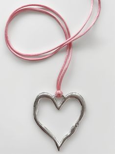 It's no surprise how this dreamy choker earned its name... You'll fall in love every time you look at it! Featuring the dreamiest pink satin cord and stunning statement-making heart pendant, the 'LOVE AT FIRST SIGHT' wrap choker is the necklace you've been waiting for. Trust us, compliments are waiting... Made with genuine satin cord and zinc alloy heart pendant. Waterproof & rust-free. 55" length - designed to allow you to tie this piece in multiple ways. Handmade with love in Los Angeles. Tying Cord Necklace, Hearts Necklaces, Heart Crystal Pendant Necklace, Heart Can Necklace, Can Tab Heart Necklace Tutorial, Handmade Pink Heart Necklace, Pink Adjustable Heart Necklace, Pink Heart-shaped Choker As A Gift, Metal Heart Pendant Choker