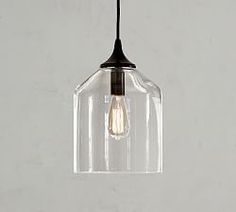 a clear glass light hanging from a ceiling