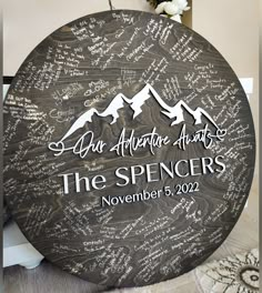 a round wooden sign with writing on it that says, the spencers november 5, 2012