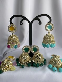 - [ELEGANT DESIGN] The jhumkas are designed to add a touch of traditional elegance to any outfit. - [VERSATILE STYLE] These earrings can be paired with a variety of ethnic wear outfits for a stunning look. - [HIGH QUALITY MATERIAL] Made with high-quality materials to ensure durability and longevity. Green Chandbalis With Latkans For Party, Multicolor Jhumkas For Navratri Festival, Multicolor Stone Work Jhumkas For Wedding, Eid Party Jhumkas With Cutdana Detail, Eid Party Jhumkas With Cutdana, Festive Party Jhumkas, Festive Green Sets With Latkans, Festive Multicolor Chandbali Jhumkas, Multicolor Chandbali Jhumkas For Festive Occasions