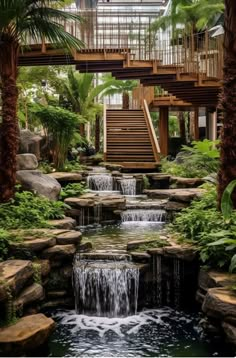 a waterfall in the middle of a tropical garden