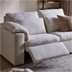 a white couch with pillows on top of it