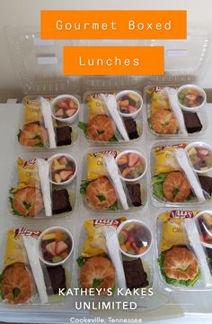 lunch boxes filled with gourmet boxed lunches, including croissants and fruit