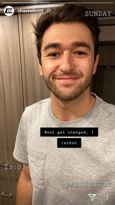 a man is smiling for the camera with his name tag on his t - shirt