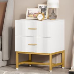 a white and yellow chest of drawers next to a bed with a lamp on top