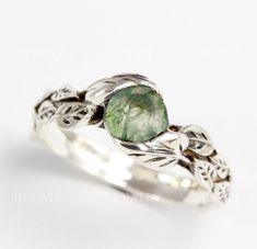 Exclusive to Benati! Natural and floral, beautiful leaves are holding this fine natural moss agate gemstone. Please note each stone has it's own character - as they are natural, no two stones are alike.  They are unique - just like you! This is a very special ring :) Leaves ring hand crafted to perfection in sterling silver or 14k gold, with some oxidized areas to show the leaves even nicer! Top quality natural round moss agate of approx. 0.80 carats. This ring has lovely natural motifs of leave Non Traditional Silver Engagement Rings, Nature-inspired Wedding Rings With Natural Stones, Miss Agate Engagement Ring Silver, Moss Agate Ring Silver, Nature-inspired Emerald Ring, Silver Moss Agate Ring, Moss Agate Engagement Ring Silver, Forest Rings, Nature-inspired Moss Agate Round Rings