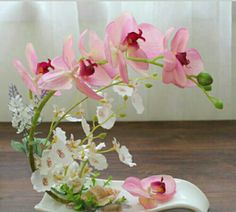 pink and white flowers in a vase on a table