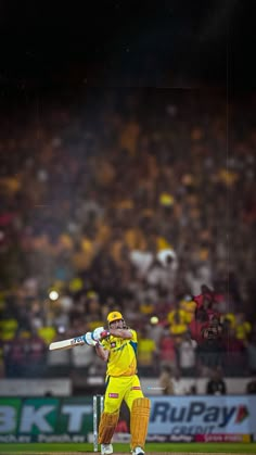 a man in yellow uniform playing a game of cricket