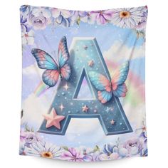 the letter a with butterflies and flowers on it is shown in front of a blue sky background