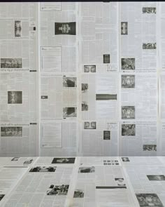 a bunch of newspapers are spread out on the table top, with papers scattered around them