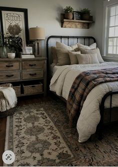 a bed sitting next to a window in a bedroom