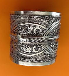 "Presenting a wonderful vintage, solid silver cuff BRACELET from Tunisia. The bracelet measures over 2 1/2\" (6,45 cm) wide and its inner diameter is 2 3/4\" (7,0 cm), though it is FULLY ADJUSTABLE. The bracelet features wonderfully textured floral and geometric designs. It has Tunisian and Libyan hallmarks for 800 silver. This piece is also an excellent size for a man's wrist." Unique Filigree Bangle Cuff Bracelet, Bohemian Etched Cuff Bracelet For Ceremonial Occasions, Ceremonial Antique Silver Cuff Bangle, Traditional Silver Wide Band Jewelry, Traditional Engraved Wide Band Jewelry, Traditional Wide Band Engraved Jewelry, Traditional Handmade Wide Band Jewelry, Silver Bohemian Cuff Bracelet For Ceremonial Occasions, Traditional Filigree Cuff Bracelet Bangle