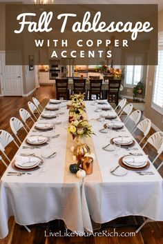 a dining room table set with place settings for fall tablescape and white linens