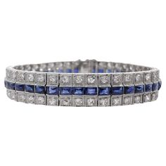 Jay Feder Art Deco Platinum Blue Sapphire and Diamond Bracelet There are 42 Blue Sapphires; estimated total weight is 8.4 carats. Set with 84 round diamonds; total carat weight is 4.2ct approx. The bracelet is 6.75 inches long and weighs 30.6 grams. Please view our photos and videos for more details. Good condition, minor evidence of wear, some tiny scratches to the metal. All stones are present. Polished, cleaned, and ready to wear. All Returns and exchanges must be authorized by the seller wit Formal Blue Platinum Bracelet, Luxury Blue Diamond Bracelet With Brilliant Cut, Blue Diamond Bracelet With Brilliant Cut Luxury Style, Blue Diamond Platinum Bracelet For Formal Occasions, Formal Blue Diamond Platinum Bracelet, Blue Diamond Jubilee Tennis Bracelet, Luxury Sapphire Tennis Bracelet With Brilliant Cut, Classic Sapphire Diamond Tennis Bracelet, Classic Sapphire Diamond Bracelet With Brilliant Cut