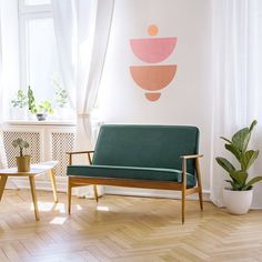 a living room filled with furniture next to a white wall and window covered in curtains