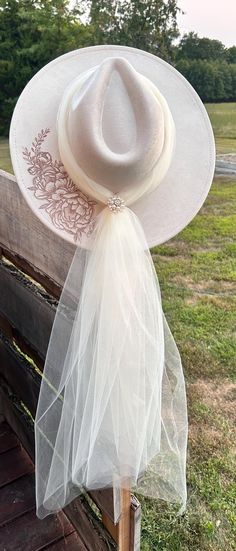 a white hat on top of a wooden bench