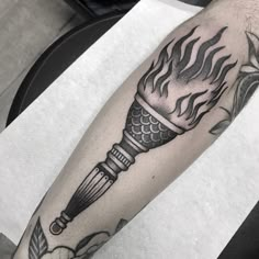 a black and white photo of a tattoo on the arm