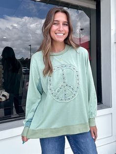 Spread peace and style with our Peace Stud Patch Sweatshirt. Made with soft cotton jersey, this top features long sleeves, rounded neckline, slightly dropped shoulders, and ribbed band cuffs and bottom for a comfortable and unique look. 72% COTTON 28% POLYESTER Trendy Long Sleeve Tops With Ribbed Neckline, Trendy Long Sleeve Top With Ribbed Neckline, Trendy Spring Long Sleeve Crew Neck Top, Fall Crew Neck Tops For Loungewear, Trendy Long Sleeve Tops With Ribbed Cuffs, Spring Long Sleeve T-shirt For Loungewear, Long Sleeve Tops With Ribbed Neckline For Spring, Casual Long Sleeve Loungewear Top For Spring, Spring Casual Long Sleeve Loungewear Top