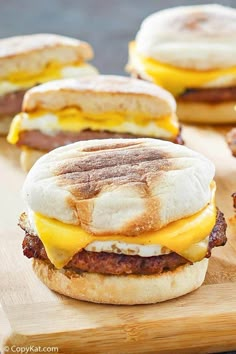 breakfast sandwiches with bacon, egg and cheese on a cutting board ready to be eaten