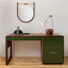 a wooden desk with two drawers and a mirror on the wall