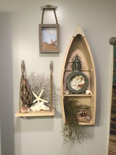 there are two boats on the wall and one is made out of driftwood with sea shells